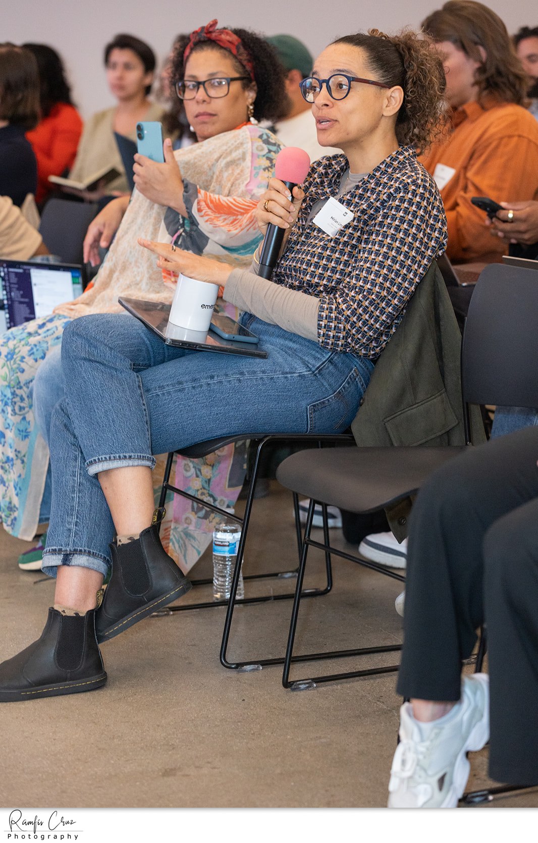 An attendee asking a question into a microphone during a panel session