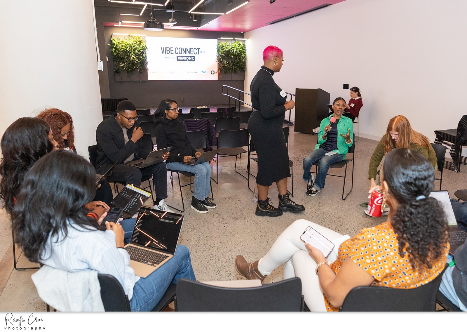 Attendees seated in a circle during a community session at a tech week event